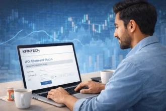 Indian investor checking IPO allotment status on KFINTECH website using a laptop with stock market charts in the background.